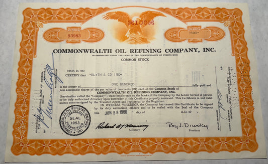 This orange stock certificate from Commonwealth Oil Refining Company, issued in 1960, features a vignette of a bald eagle, symbolizing strength and freedom. The certificate includes cancellation holes, stamps, and handwritten annotations, marking its authenticity and previous transactions.