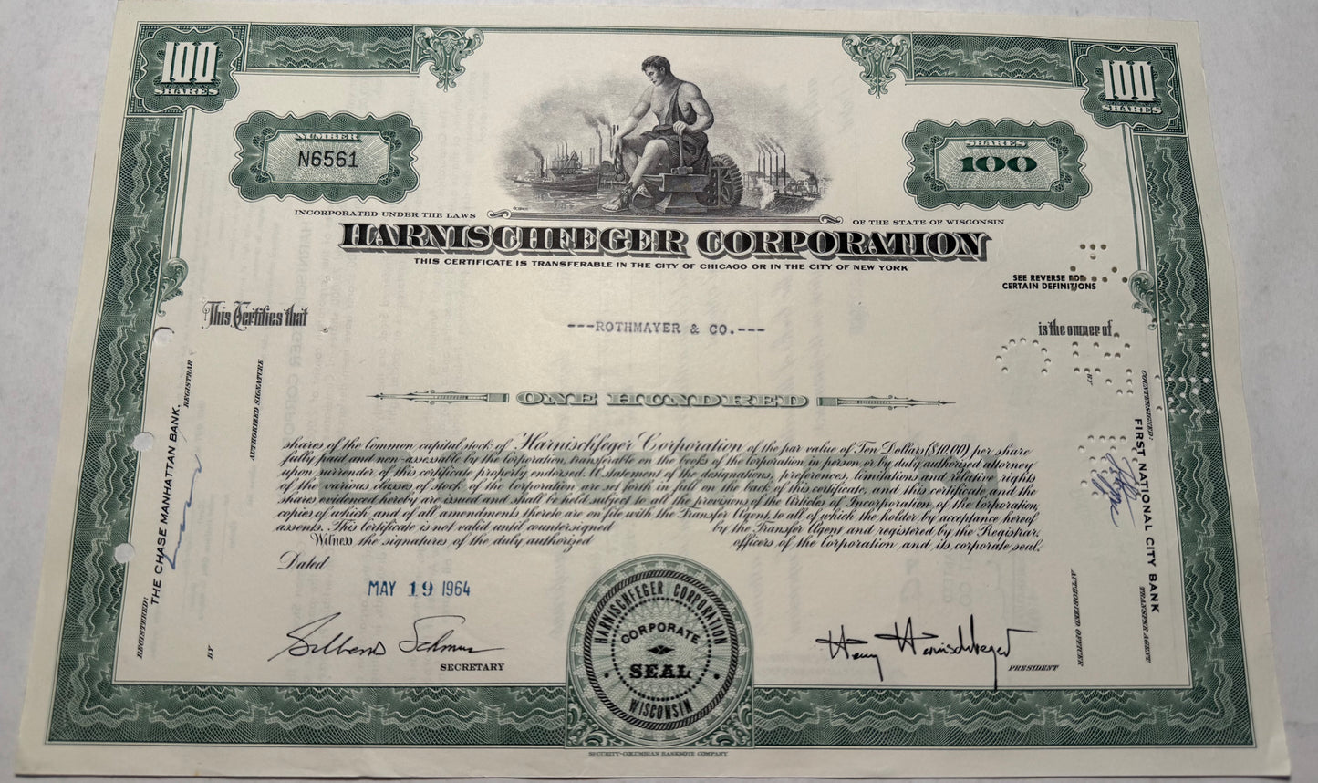 Harnischferger Corporation Stock Certificate, green issued 1964, cancellation holes, stamps and writing present.