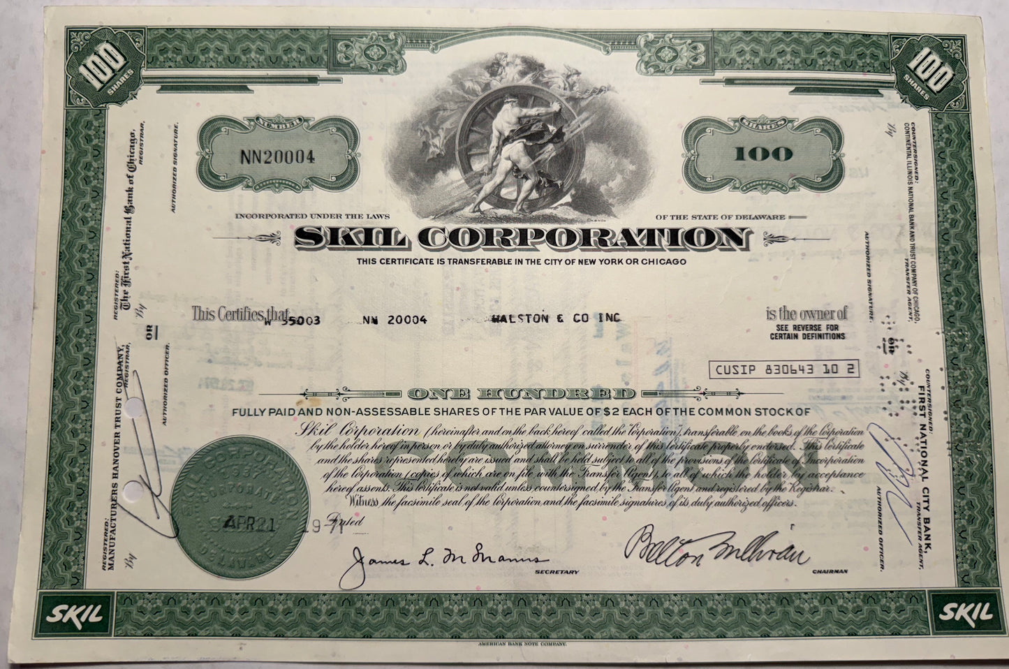 This is a green stock certificate from Skill Corporation, issued in 1971. It features a vignette of a strong man turning a wheel and is registered in Delaware.