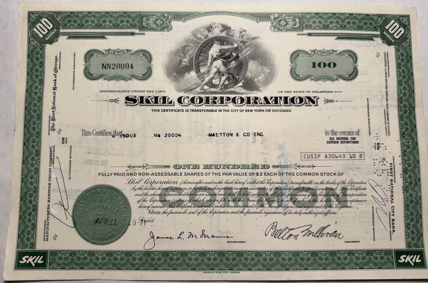 This is a green stock certificate from Skill Corporation, issued in 1971. It features a vignette of a strong man turning a wheel and is registered in Delaware.