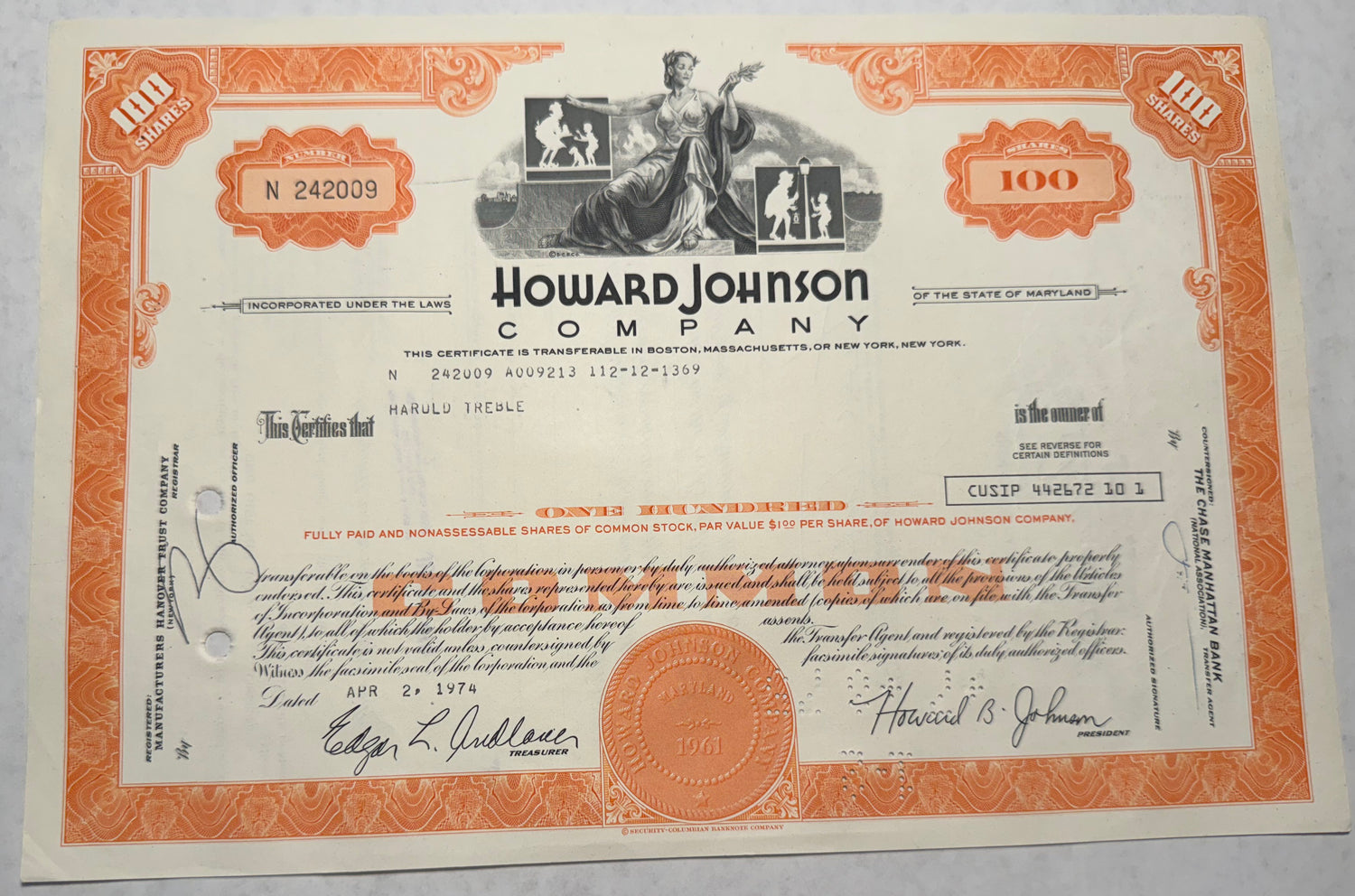 Howard Johnson Company Stock Certificate, orange issued in 1974 cancellation holes, stamps and writing on the certificate 