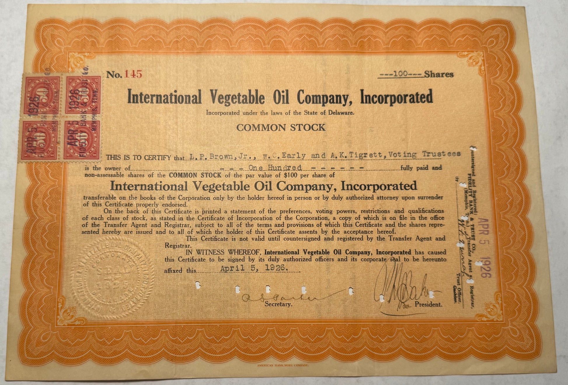  This orange stock certificate from the International Vegetable Oil Company, issued in 1926, features cancellation holes, stamps, and handwritten annotations, indicating its authenticity and historical use.